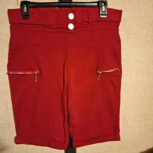 'Thrill Jeans' red cuffed shorts with zipper accents.
